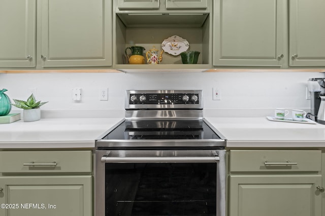 kitchen featuring green cabinetry and stainless steel electric stove