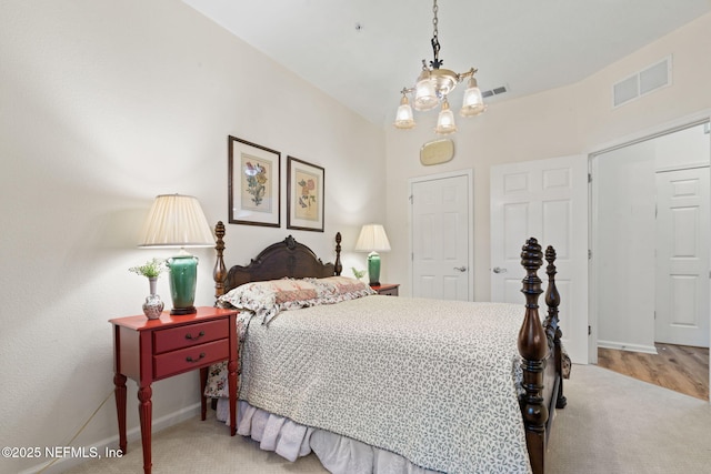 bedroom with carpet floors and a chandelier