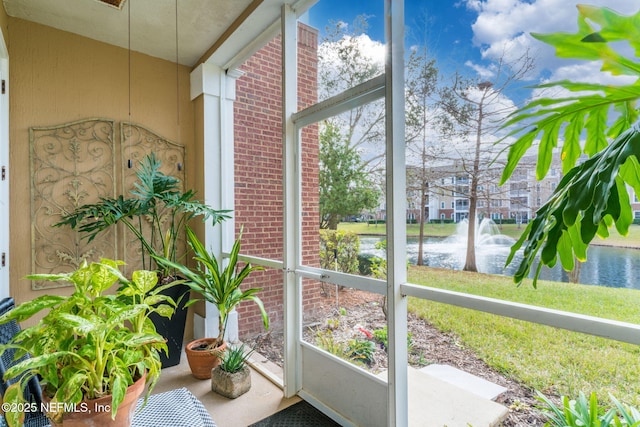 unfurnished sunroom featuring a water view