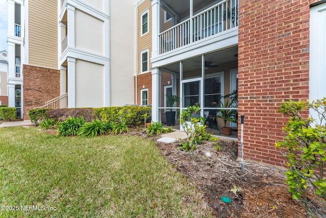 exterior space with a yard and ceiling fan