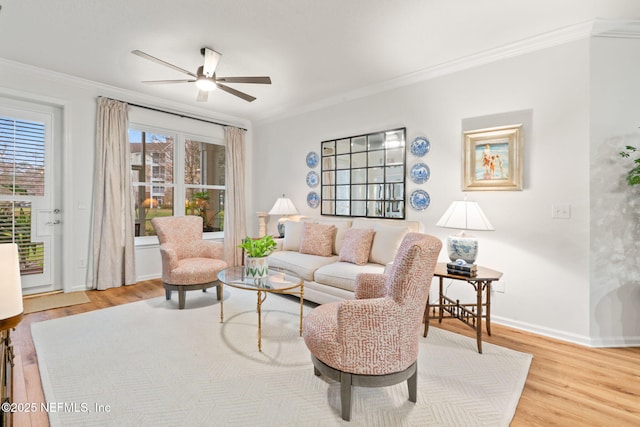 living room featuring hardwood / wood-style flooring, ornamental molding, and ceiling fan