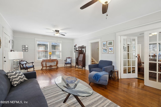 living room with hardwood / wood-style flooring, ceiling fan, and french doors