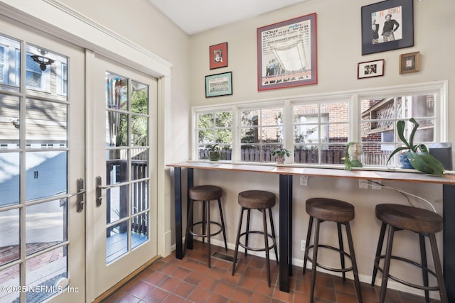 interior space with dark tile patterned flooring and french doors