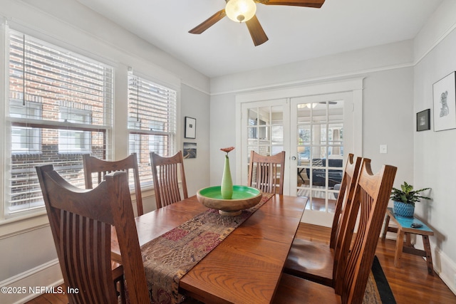 dining space with ceiling fan, french doors, a wealth of natural light, and dark wood-type flooring