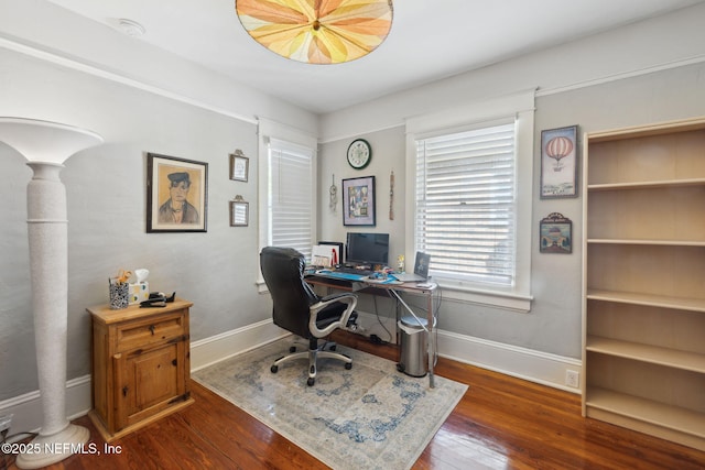 office space featuring ornate columns and dark hardwood / wood-style flooring