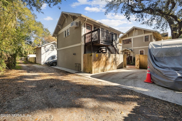 view of side of property featuring a wall mounted AC