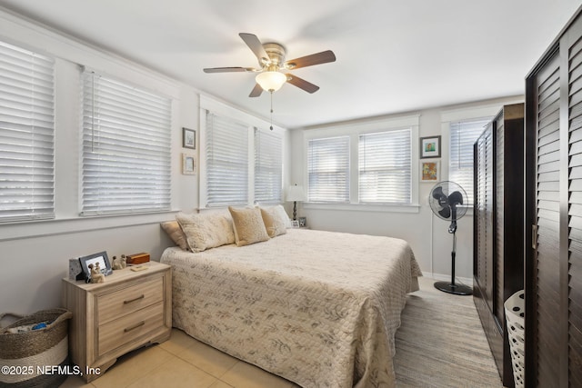 tiled bedroom with ceiling fan