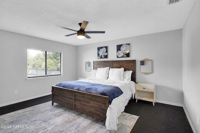 bedroom featuring a textured ceiling and ceiling fan