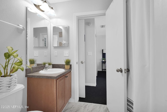 bathroom featuring toilet and vanity