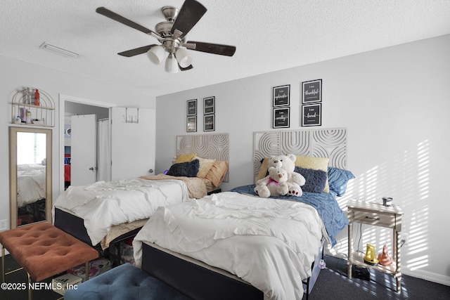 bedroom featuring a textured ceiling and ceiling fan