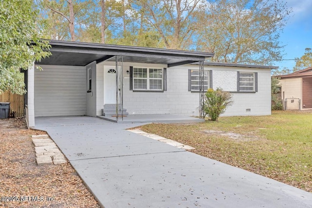 single story home featuring a front yard and a carport