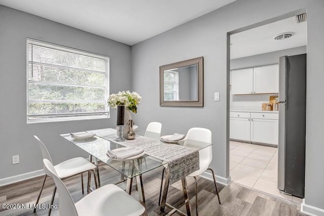 dining area with light hardwood / wood-style floors