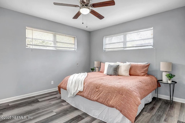 bedroom with ceiling fan and dark hardwood / wood-style flooring