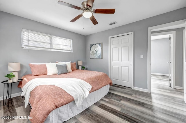 bedroom featuring hardwood / wood-style floors, a closet, and ceiling fan