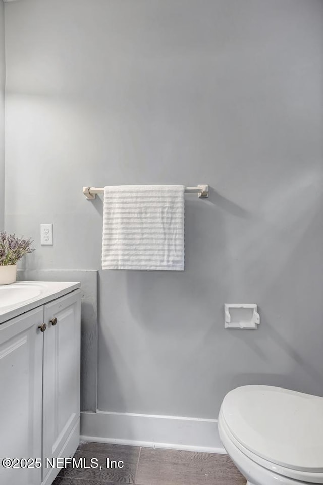 bathroom featuring toilet and vanity