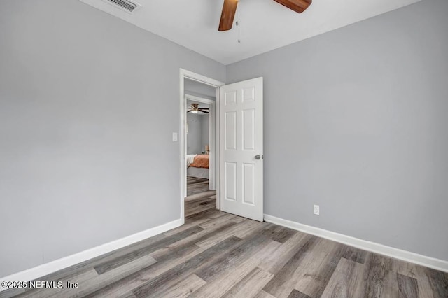 unfurnished bedroom with ceiling fan and hardwood / wood-style floors