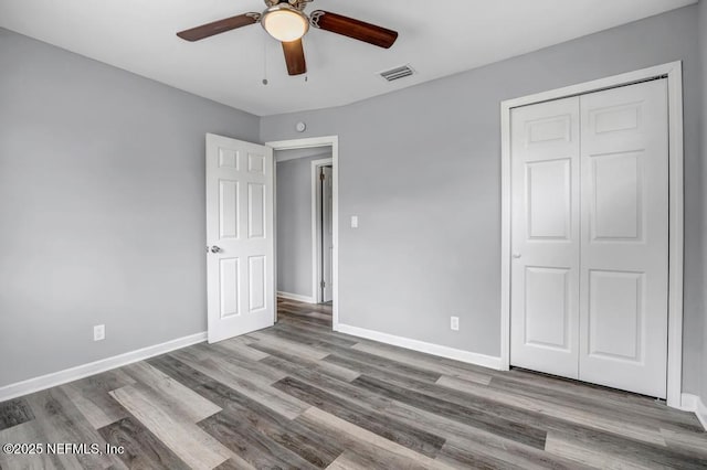 unfurnished bedroom with ceiling fan, a closet, and light hardwood / wood-style flooring