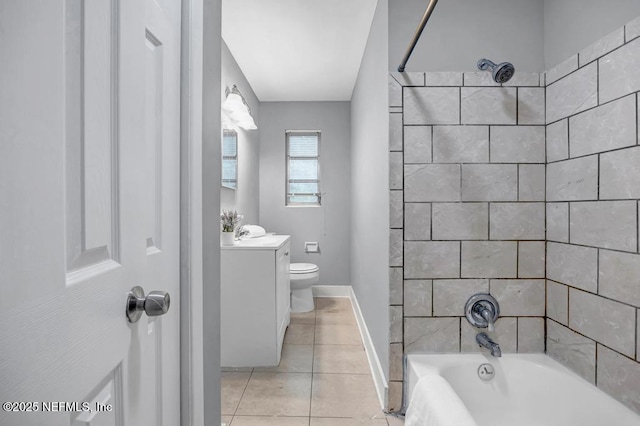 full bathroom featuring tiled shower / bath combo, toilet, tile patterned floors, and vanity