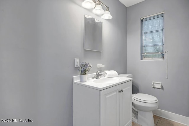 bathroom with vanity, toilet, and tile patterned floors