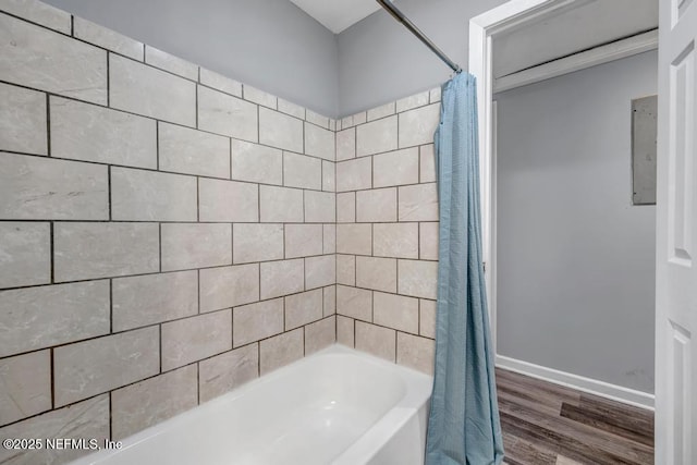 bathroom with shower / bath combo with shower curtain and hardwood / wood-style floors