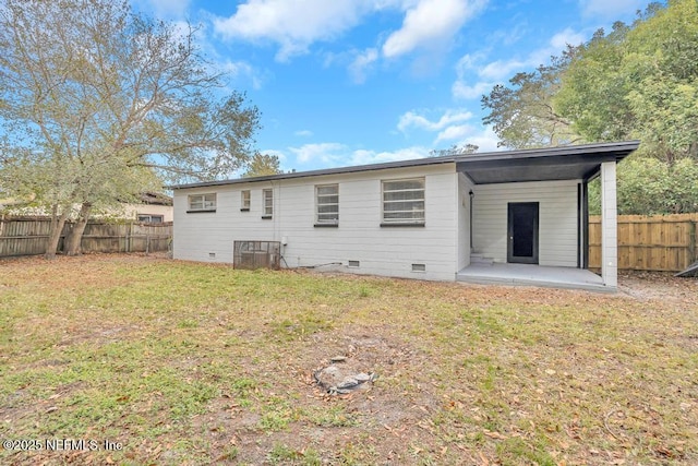 back of property featuring a patio and a yard