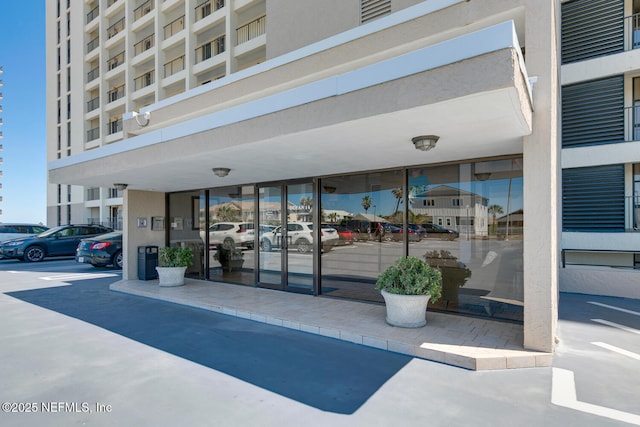 entrance to property featuring uncovered parking