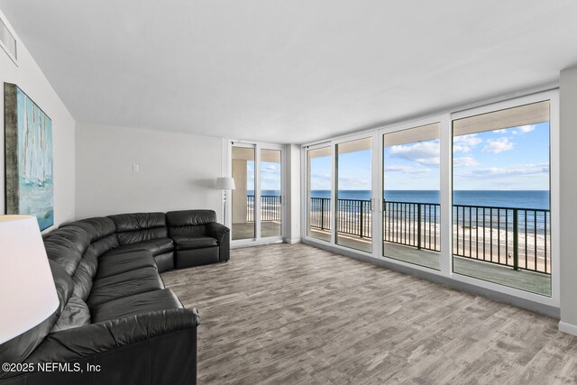 living area featuring a water view and wood finished floors