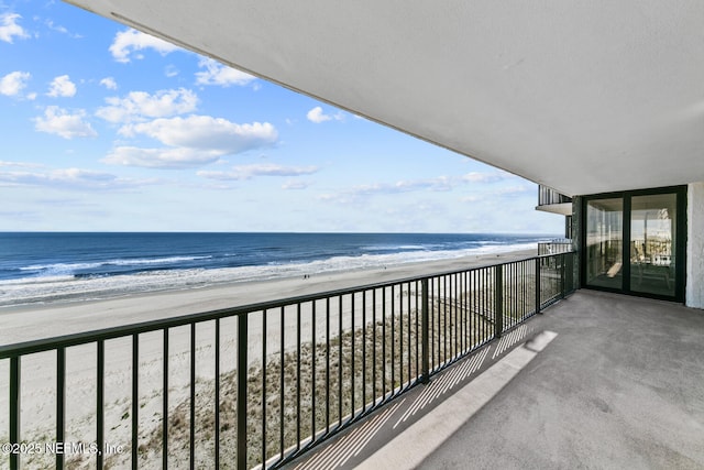 balcony featuring a water view and a view of the beach