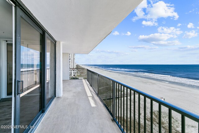 balcony with a beach view and a water view