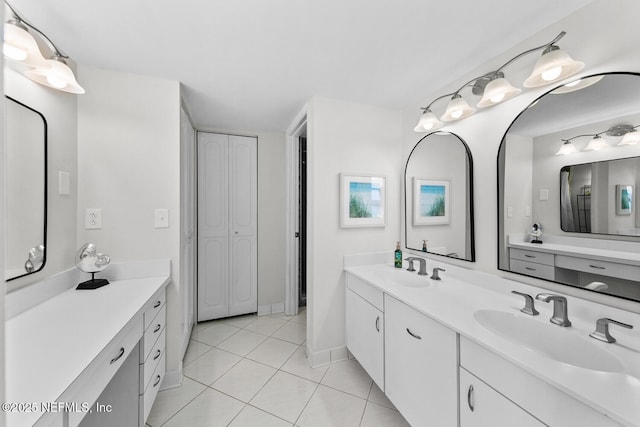 full bathroom featuring double vanity, a sink, and tile patterned floors