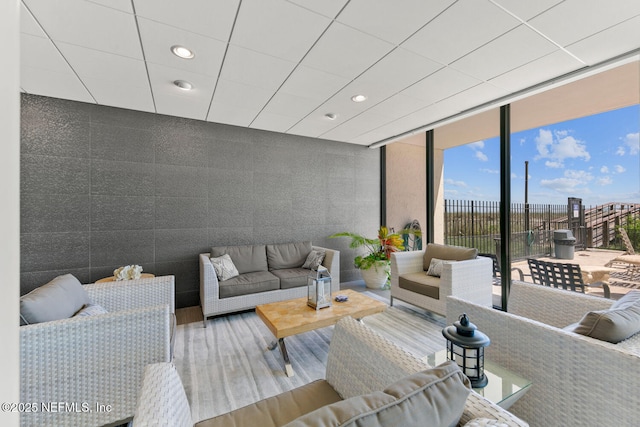 living area featuring recessed lighting, floor to ceiling windows, and wood finished floors