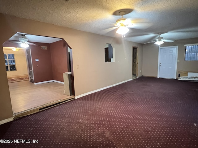 interior space featuring a textured ceiling and ceiling fan