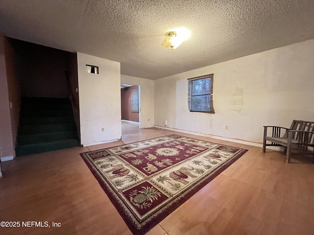 spare room with hardwood / wood-style flooring and a textured ceiling