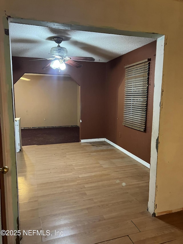 spare room featuring ceiling fan, a textured ceiling, and hardwood / wood-style floors