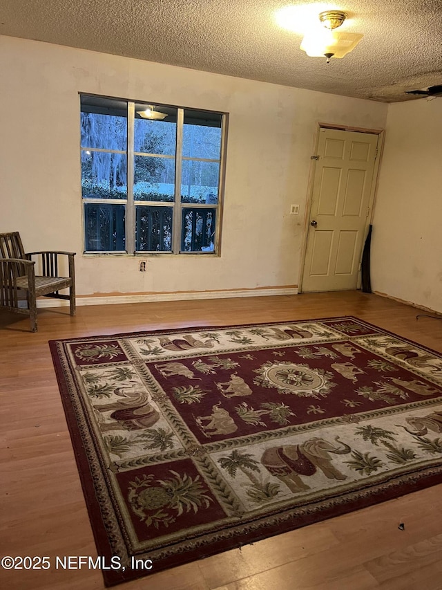 foyer entrance with wood-type flooring and a textured ceiling