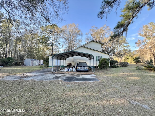 exterior space featuring a yard, a carport, and a shed