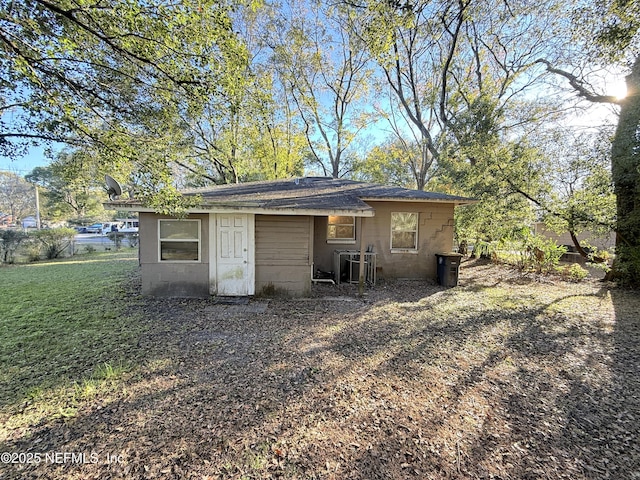 view of outbuilding featuring a lawn