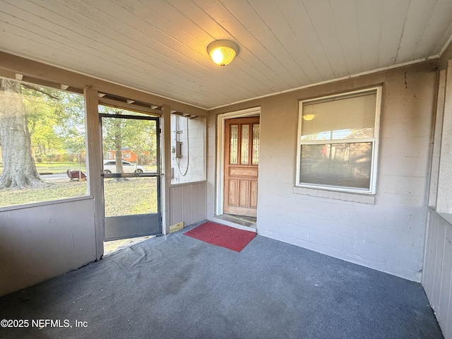 unfurnished sunroom with wooden ceiling