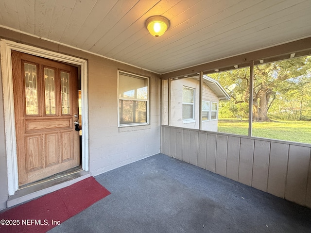 unfurnished sunroom with wood ceiling