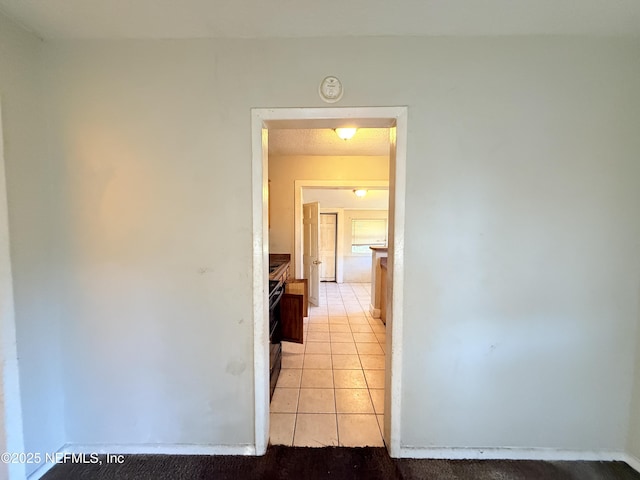 hallway with light tile patterned floors