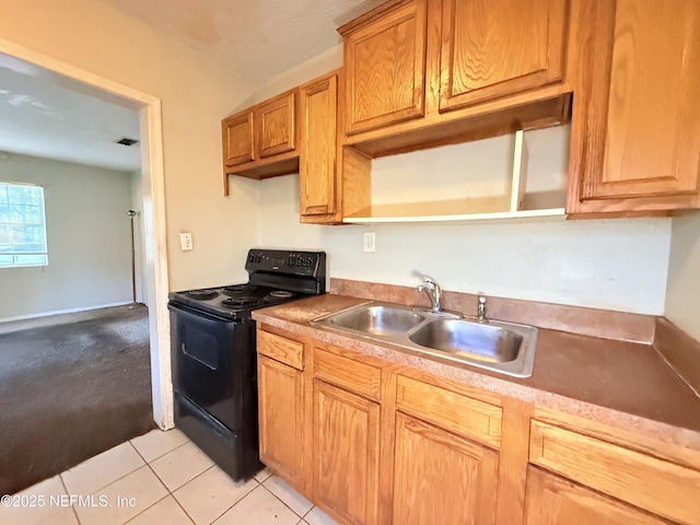 kitchen with sink, light tile patterned flooring, and black / electric stove