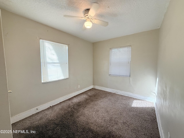 carpeted empty room with ceiling fan and a textured ceiling