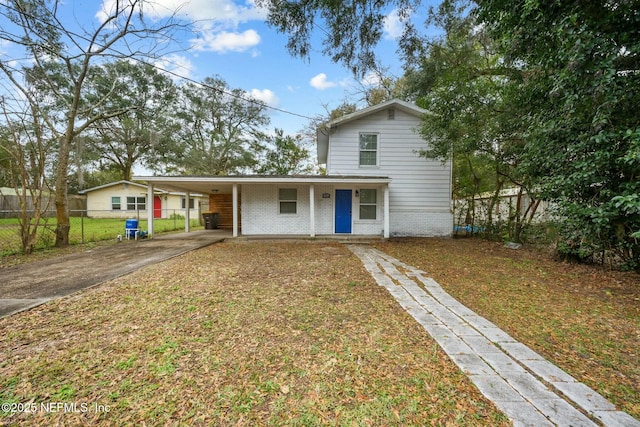 view of front of property with a carport and a front lawn