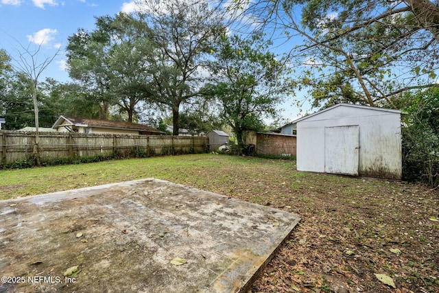 view of yard with a shed and a patio area