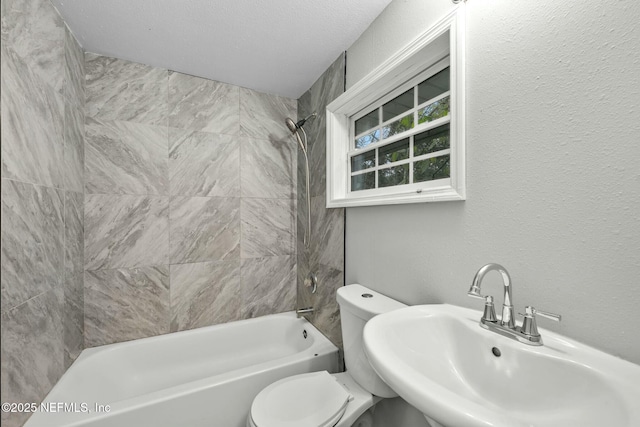 full bathroom with sink, toilet, and tiled shower / bath