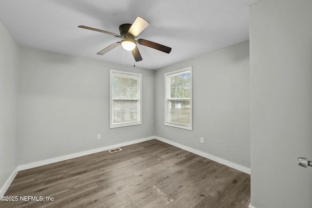 unfurnished room featuring ceiling fan and dark hardwood / wood-style floors