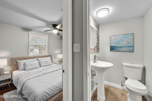 bedroom with sink and hardwood / wood-style floors