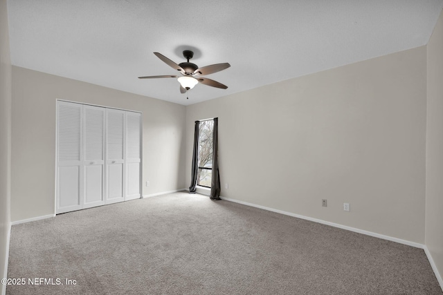 unfurnished bedroom with ceiling fan, carpet flooring, and a closet