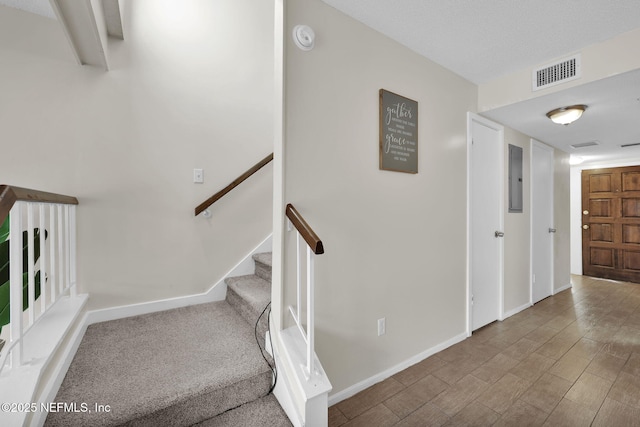 staircase featuring electric panel