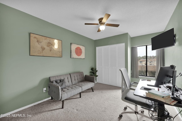 carpeted office with ceiling fan and a textured ceiling